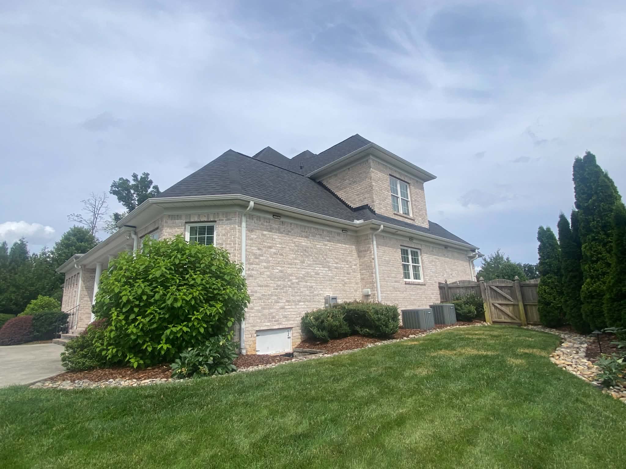 Side view of a completed dark shingle roof